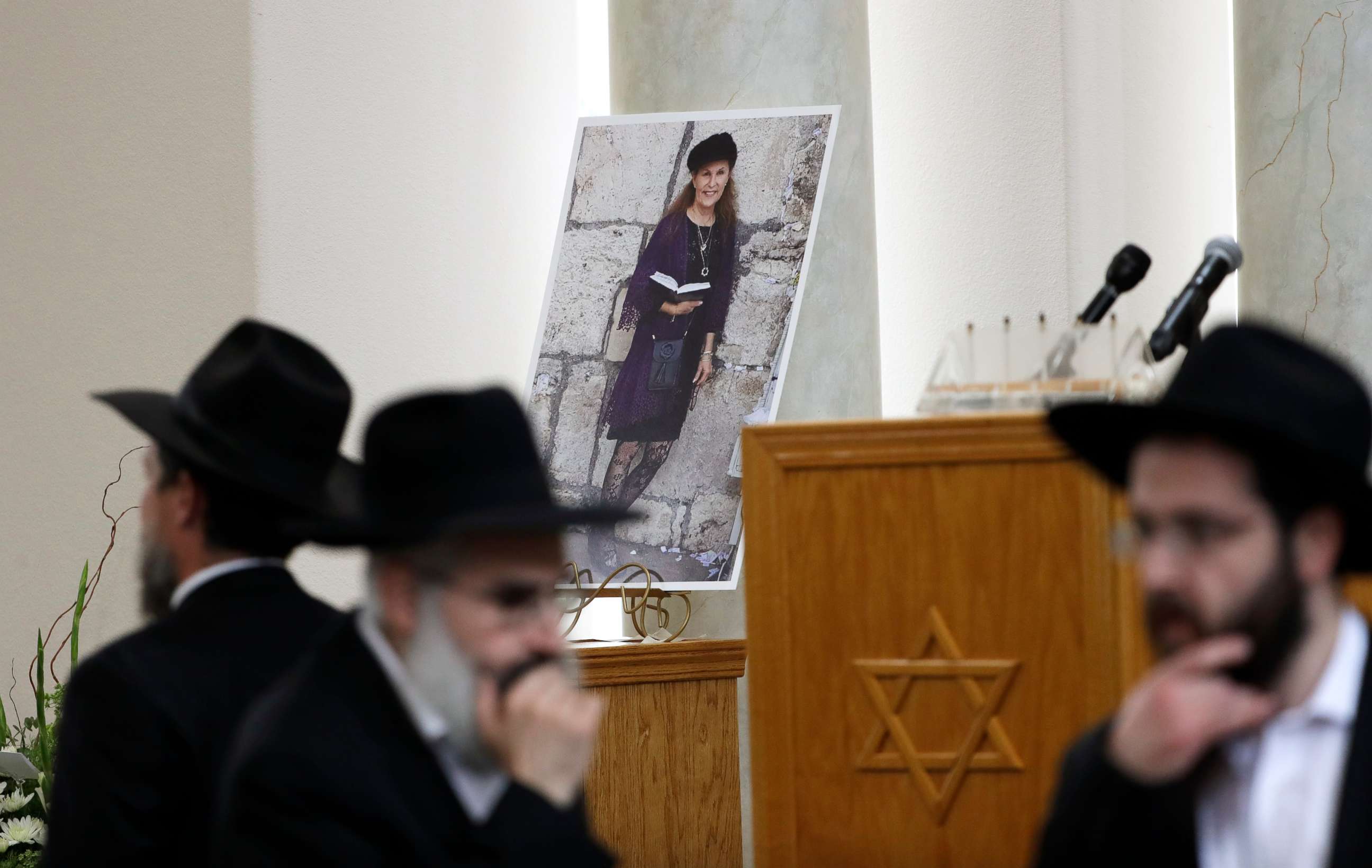 PHOTO: Attendees at the funeral for Lori Kaye, who was killed when a gunman opened fire inside the Chabad of Poway synagogue in Poway, Calif., pass by a photo of Kaye, April 29, 2019, inside the synagogue. 