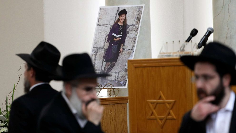 PHOTO: Attendees at the funeral for Lori Kaye, who was killed when a gunman opened fire inside the Chabad of Poway synagogue in Poway, Calif., pass by a photo of Kaye, April 29, 2019, inside the synagogue. 