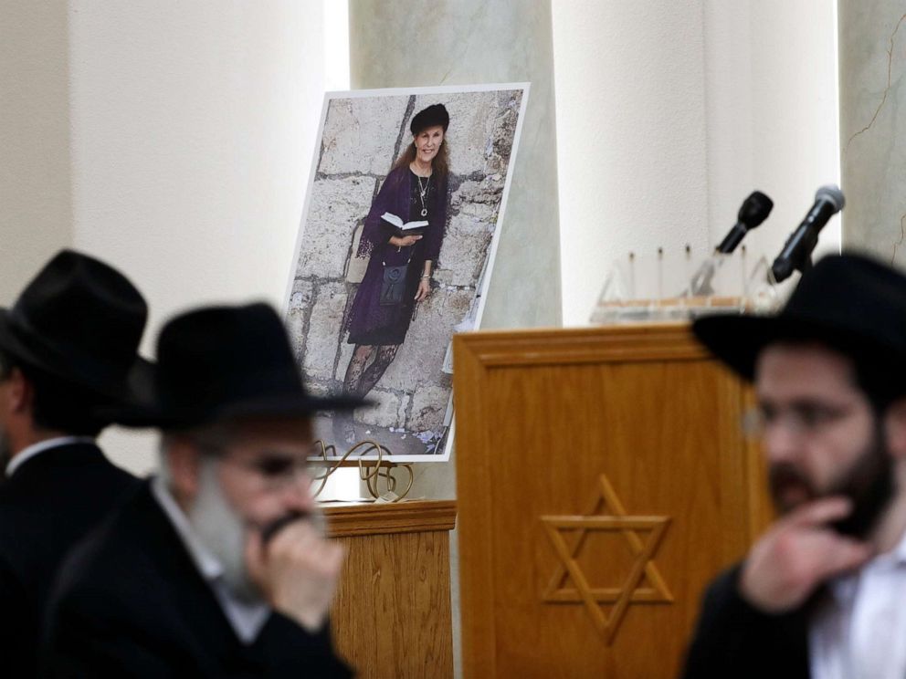 PHOTO: Attendees at the funeral for Lori Kaye, who was killed when a gunman opened fire inside the Chabad of Poway synagogue in Poway, Calif., pass by a photo of Kaye, April 29, 2019, inside the synagogue.