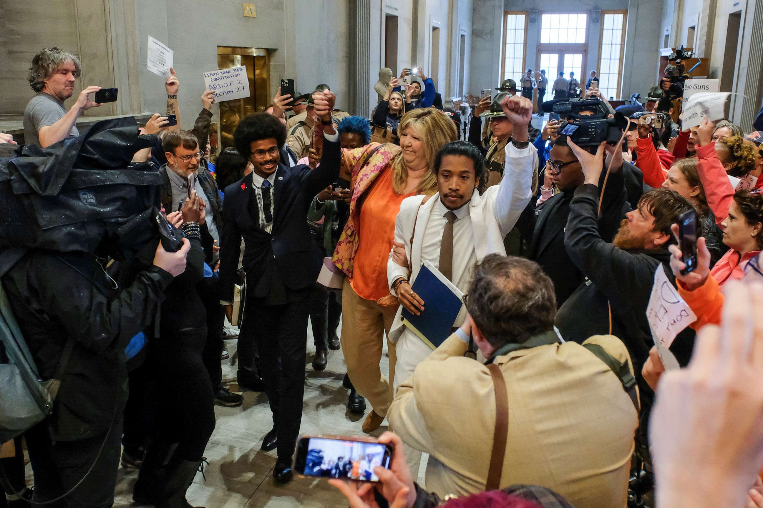 PHOTO: Tennessee State Representative Justin Pearson, Gloria Johnson and Justin Jones hold hands as they walk in the State House in Nashville, Tenn., April 6, 2023.