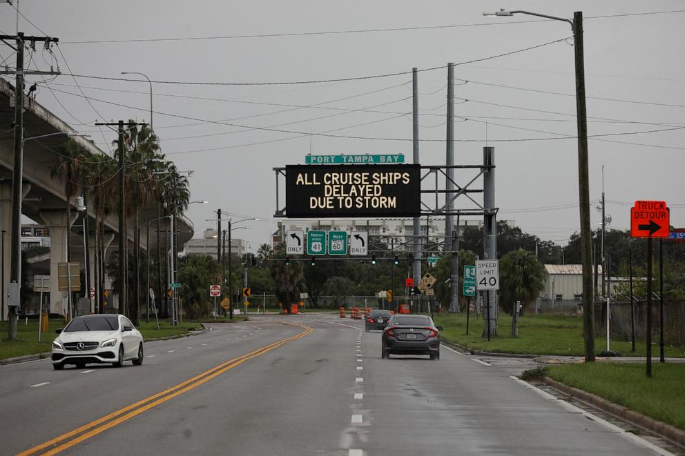 PHOTO: A street sign reading "All Cruise Ships Delayed Due To Storm" is displayed before the arrival of Hurricane Milton in Tampa, Florida, on Oct. 8, 2024.