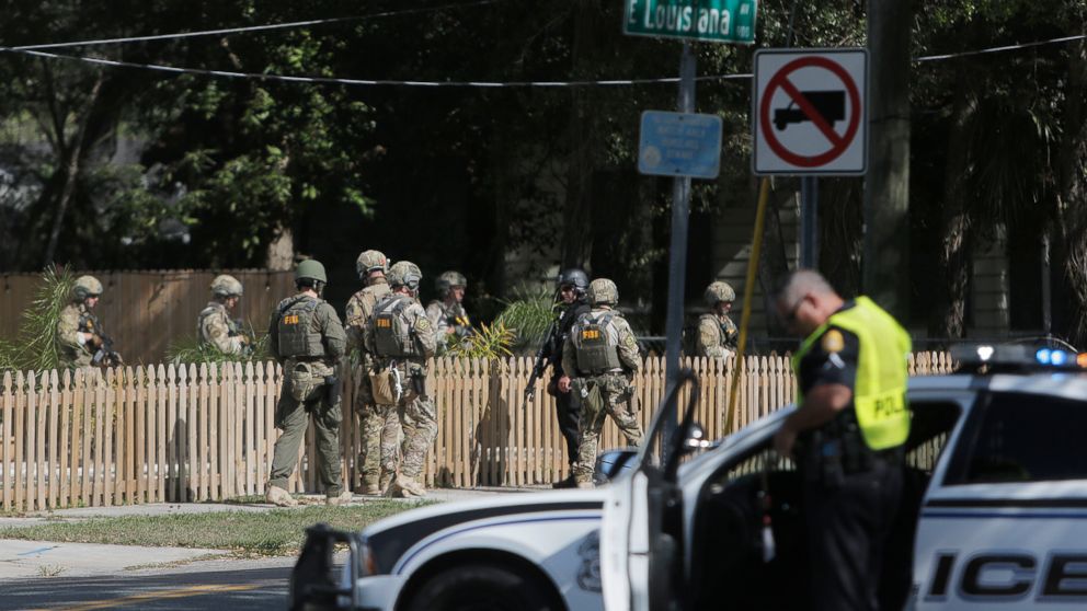 An FBI unit dressed in military uniforms joins the investigation of a fatal shooting in the Seminole Heights neighborhood in Tampa, Fla., Nov. 14, 2017.