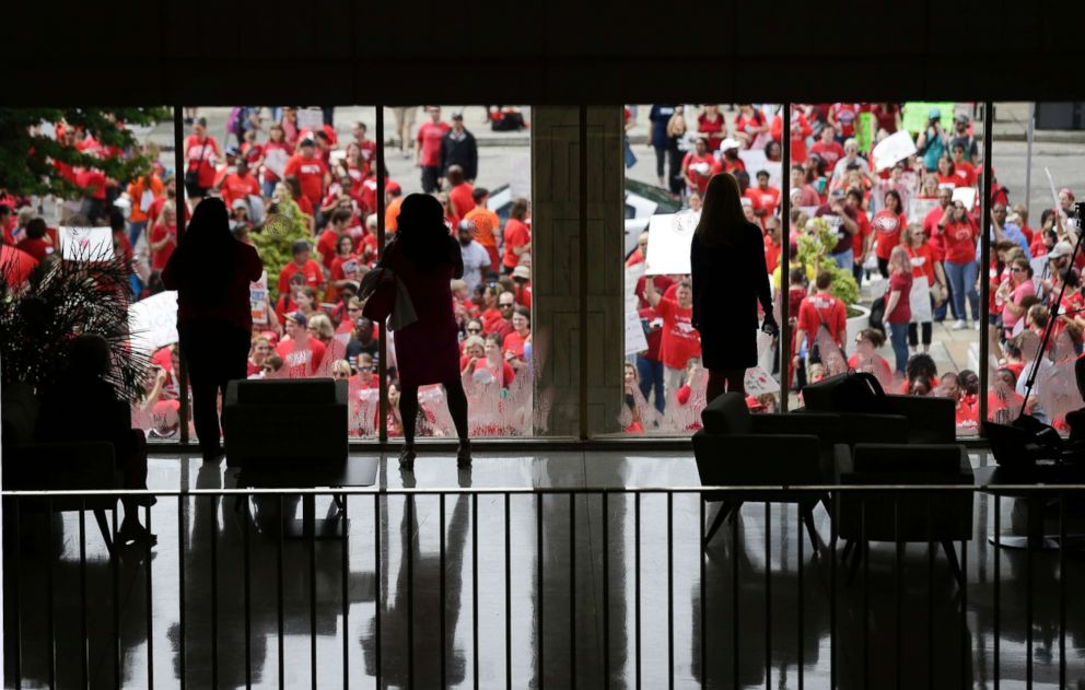 PHOTO: People watch from inside the Legislative Building as participants gather during a teachers rally at the General Assembly in Raleigh, N.C., on May 16, 2018.