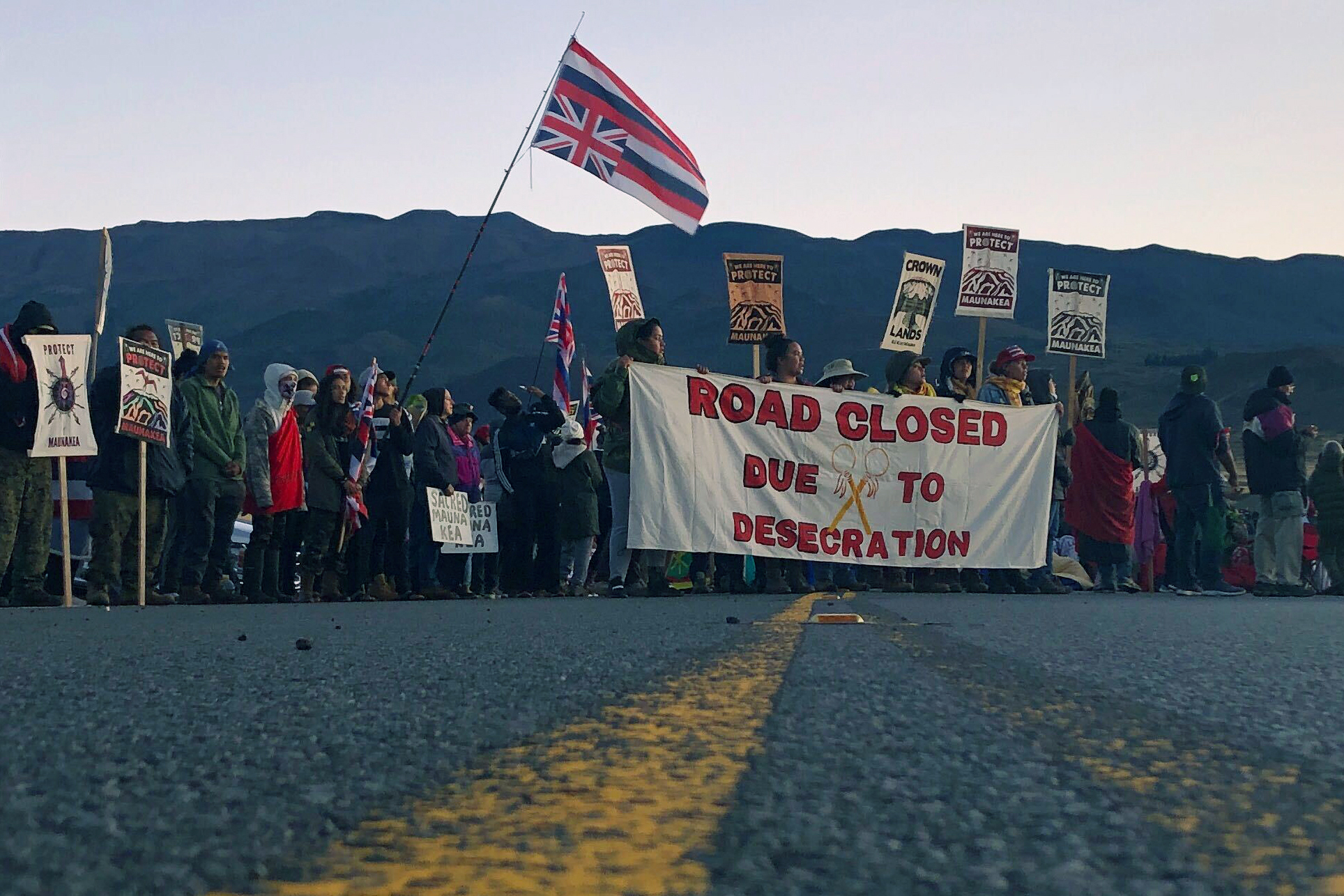 PHOTO: Demonstrators block a road at the base of Hawaii's tallest mountain, July 15, 2019, in Mauna Kea, Hawaii, to protest the construction of a giant telescope on land that some Native Hawaiians consider sacred.