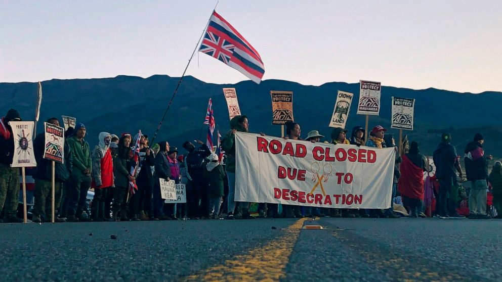 PHOTO: Demonstrators block a road at the base of Hawaii's tallest mountain, July 15, 2019, in Mauna Kea, Hawaii, to protest the construction of a giant telescope on land that some Native Hawaiians consider sacred.