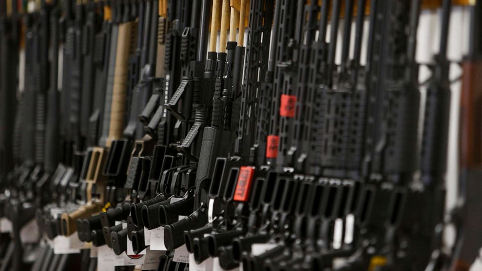 PHOTO: Rows of firearms for sale lean on the racks behind the counter at Tennessee Gun Country in Clarksville, Tenn., June 2, 2021.