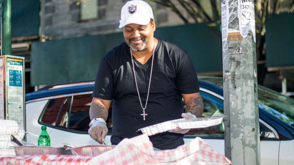 PHOTO: Tyrone Brown serves food outside of his Brooklyn restaurant The Bergen.