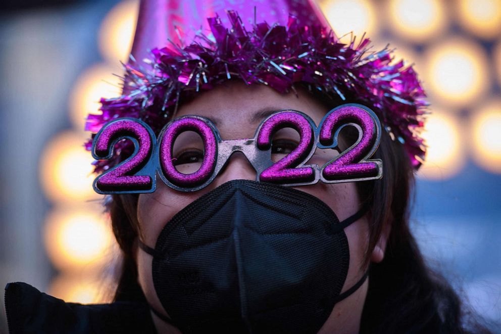 PHOTO: Teresa Hui poses for photos before the 2022 numerals to be used at a new year countdown event in Times Square in New York, Dec. 20, 2021. 
