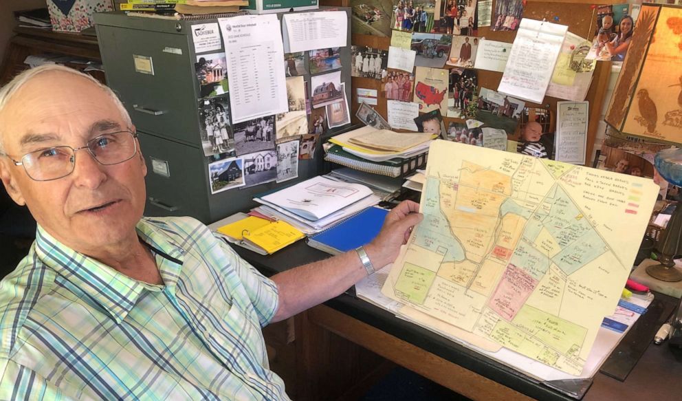 PHOTO: Tom Barnes sits in his home office, holding a map he drew of his familys land holdings dating back to when the Barneses arrived in this area near Williamsport, Ohio, in 1951.