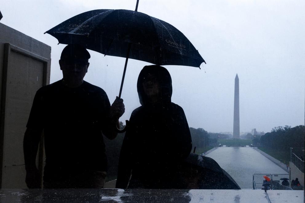 PHOTO: Tourists are seen on the National Mall during heavy rain from tropical storm Debby in Washington, D.C., Aug. 8, 2024. 