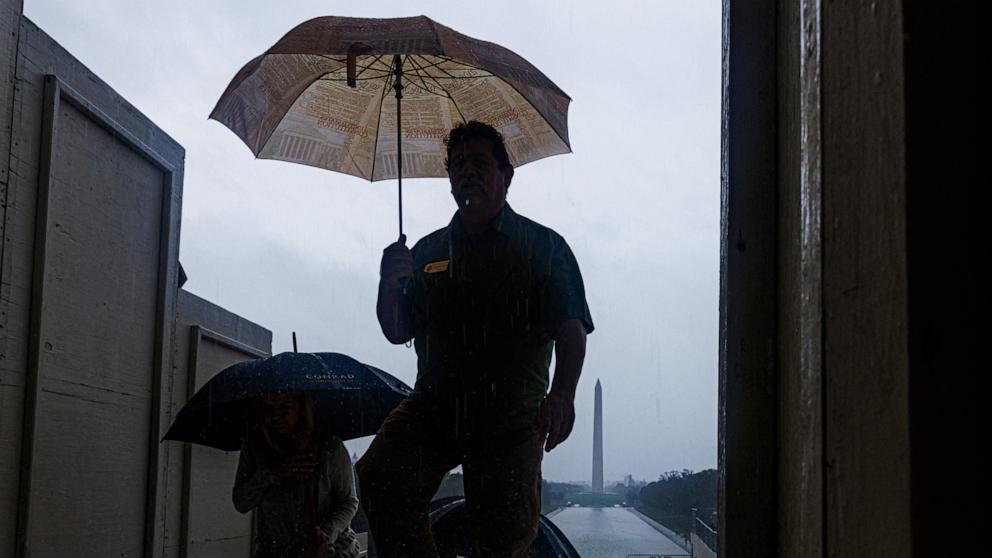 PHOTO:Tourists are seen on the National Mall during heavy rain from tropical storm Debby in Washington, D.C., Aug. 8, 2024. 