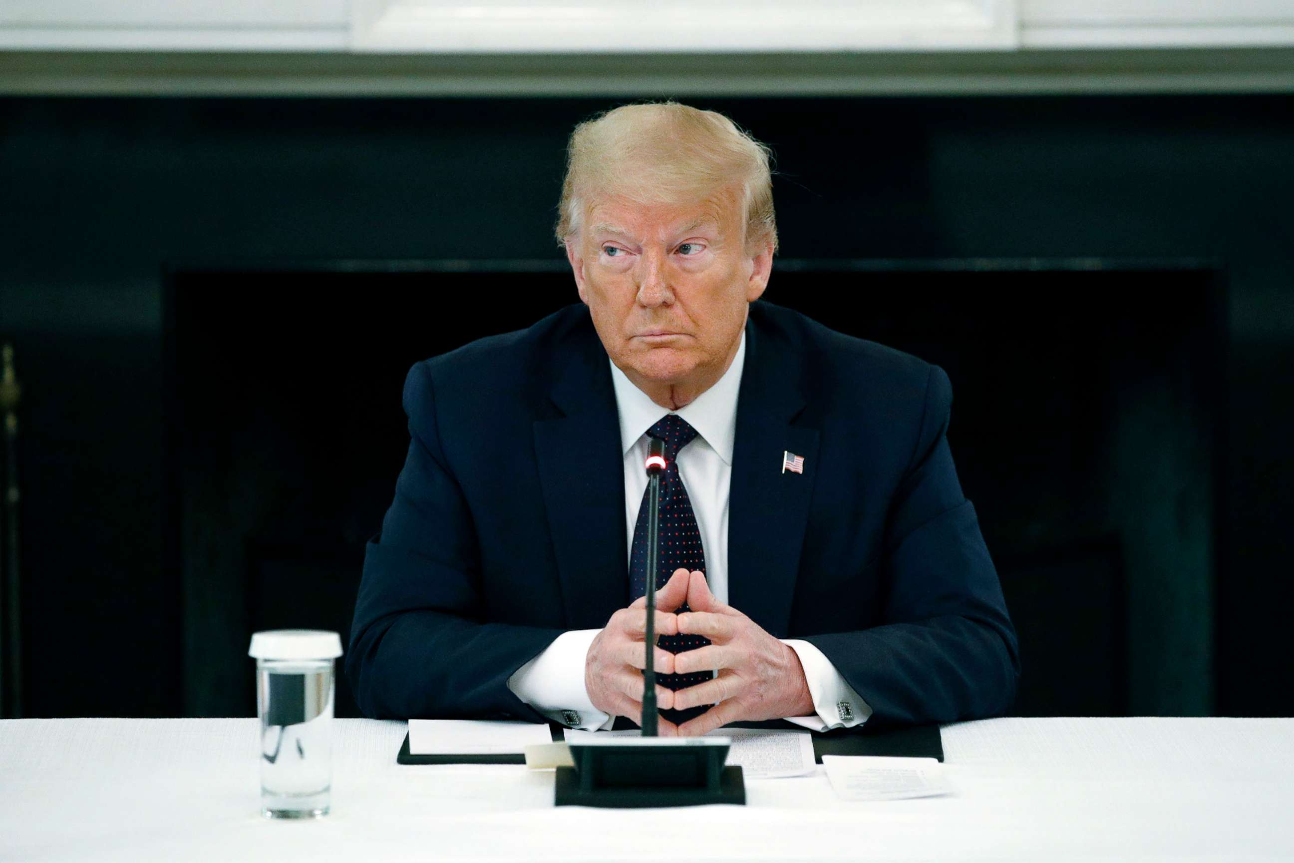 PHOTO: President Donald Trump listens during a roundtable discussion with law enforcement officials, June 8, 2020, in the State Dining Room of the White House.