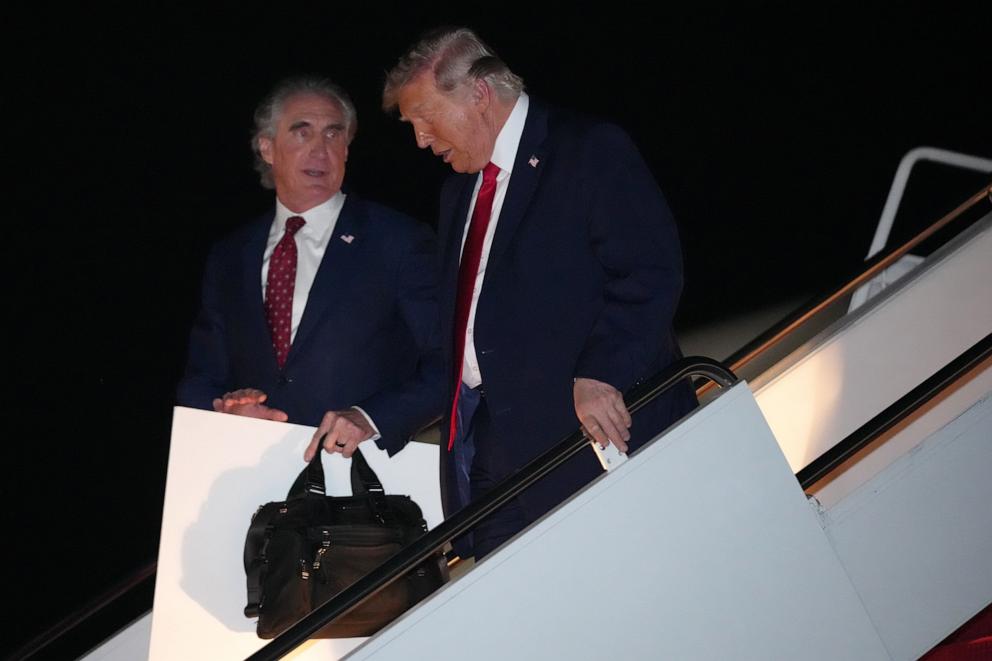 PHOTO: President Donald Trump talks with Interior Secretary Doug Burgum as he steps off Air Force One, early on June 9, 2026, at Joint Base Andrews, Md.