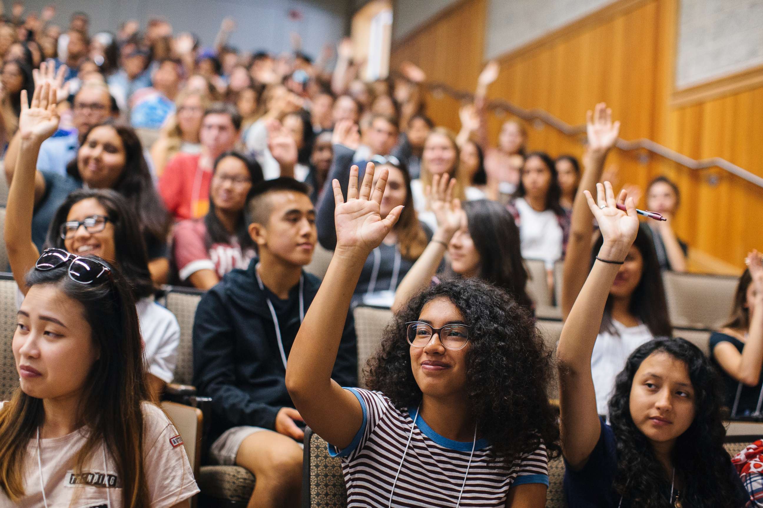 PHOTO: Students raise their hands to self-identify as first-generation during an orientation session at the University of California, Davis.