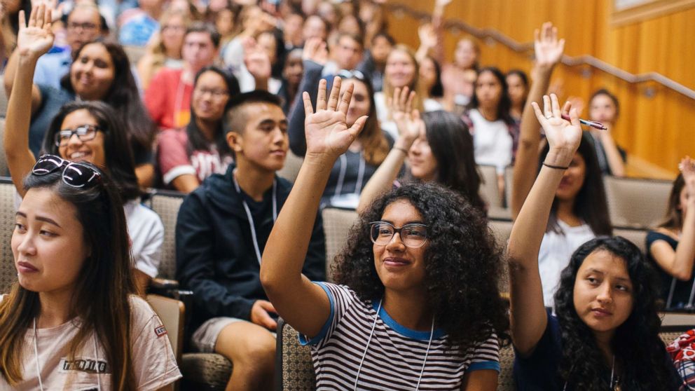 PHOTO: Students raise their hands to self-identify as first-generation during an orientation session at the University of California, Davis.