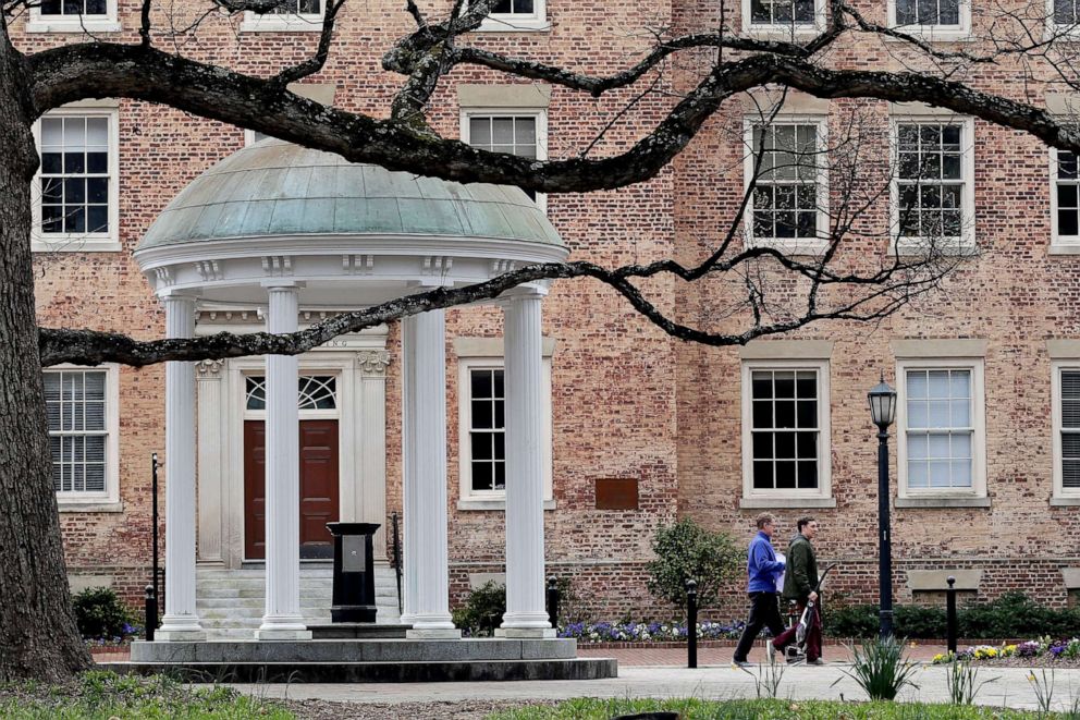 PHOTO: People remove belongings on campus at the University of North Carolina in Chapel Hill, N.C., amid the coronavirus pandemic, March 18, 2020. 