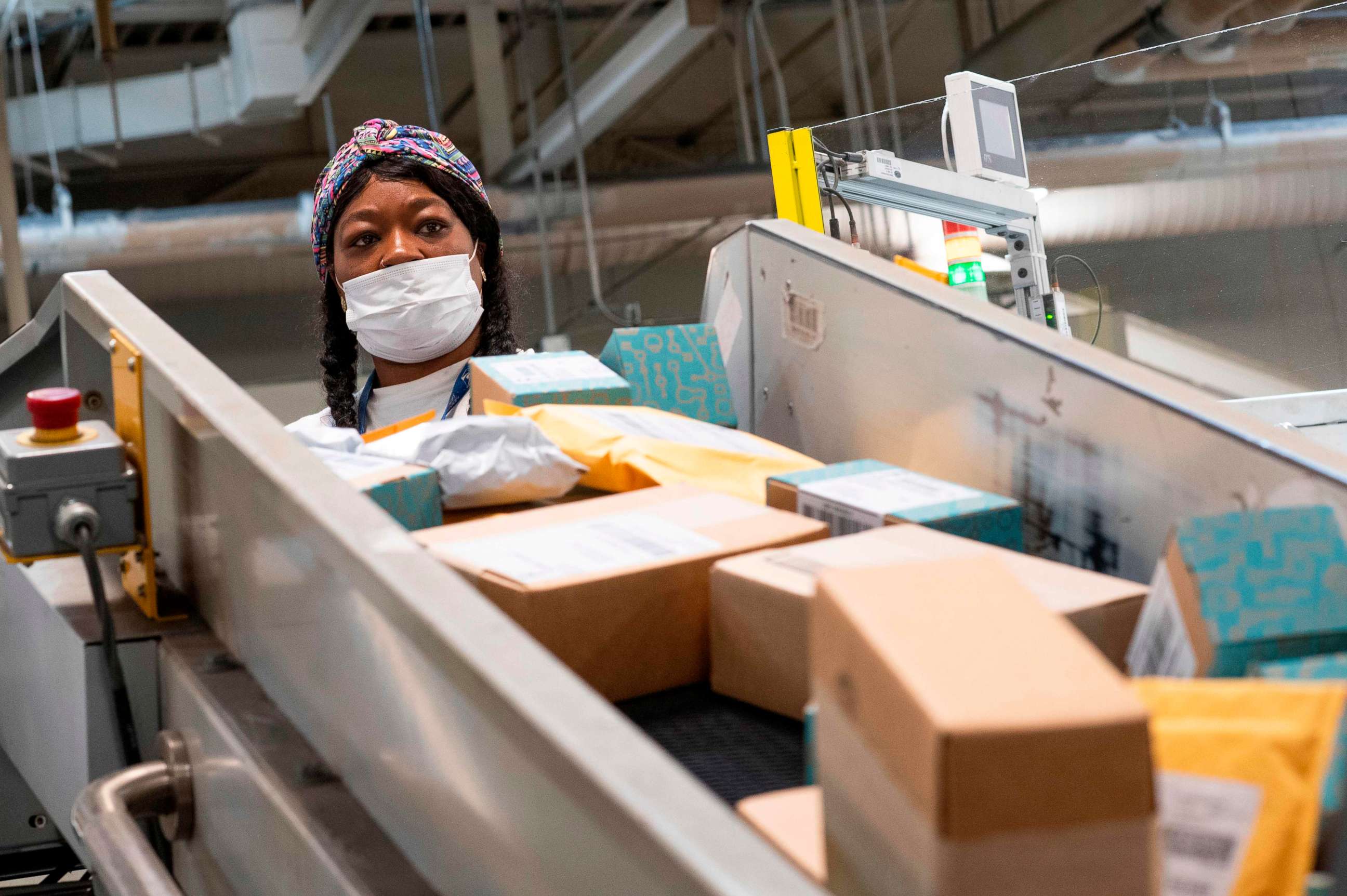 PHOTO: (FILES) In this file photo taken on April 30, 2020, a postal worker sort mail at a Los Angeles, California, facility.