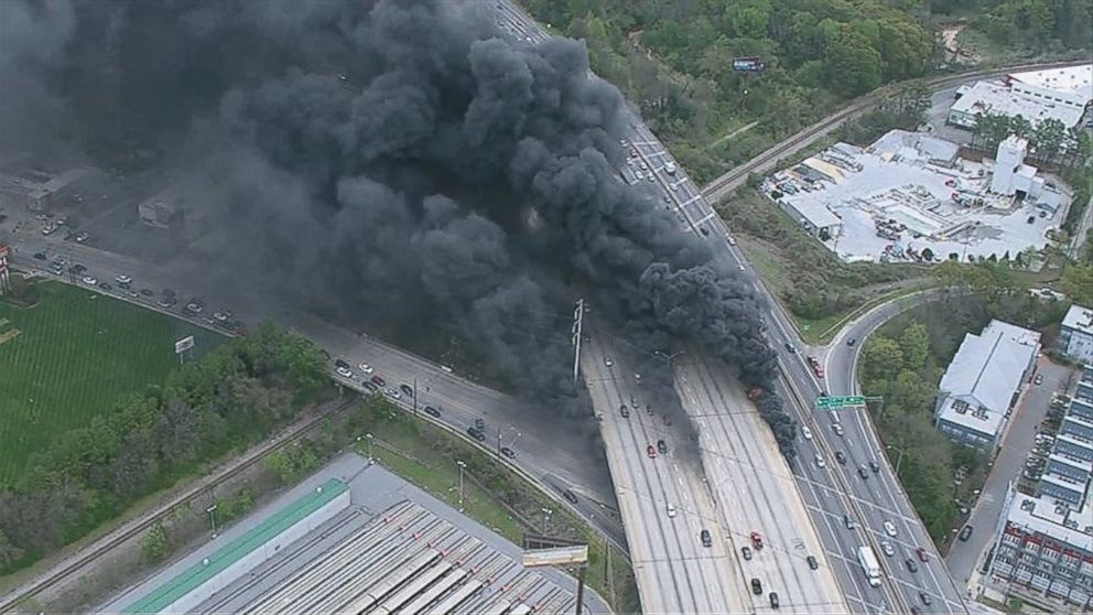 PHOTO: A massive fire burns underneath an overpass of Interstate 85 in Midtown as seen from an aerial view.