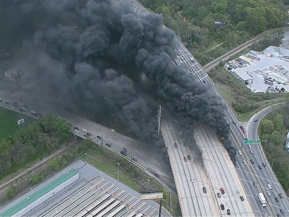 PHOTO: A massive fire burns underneath an overpass of Interstate 85 in Midtown as seen from an aerial view.
