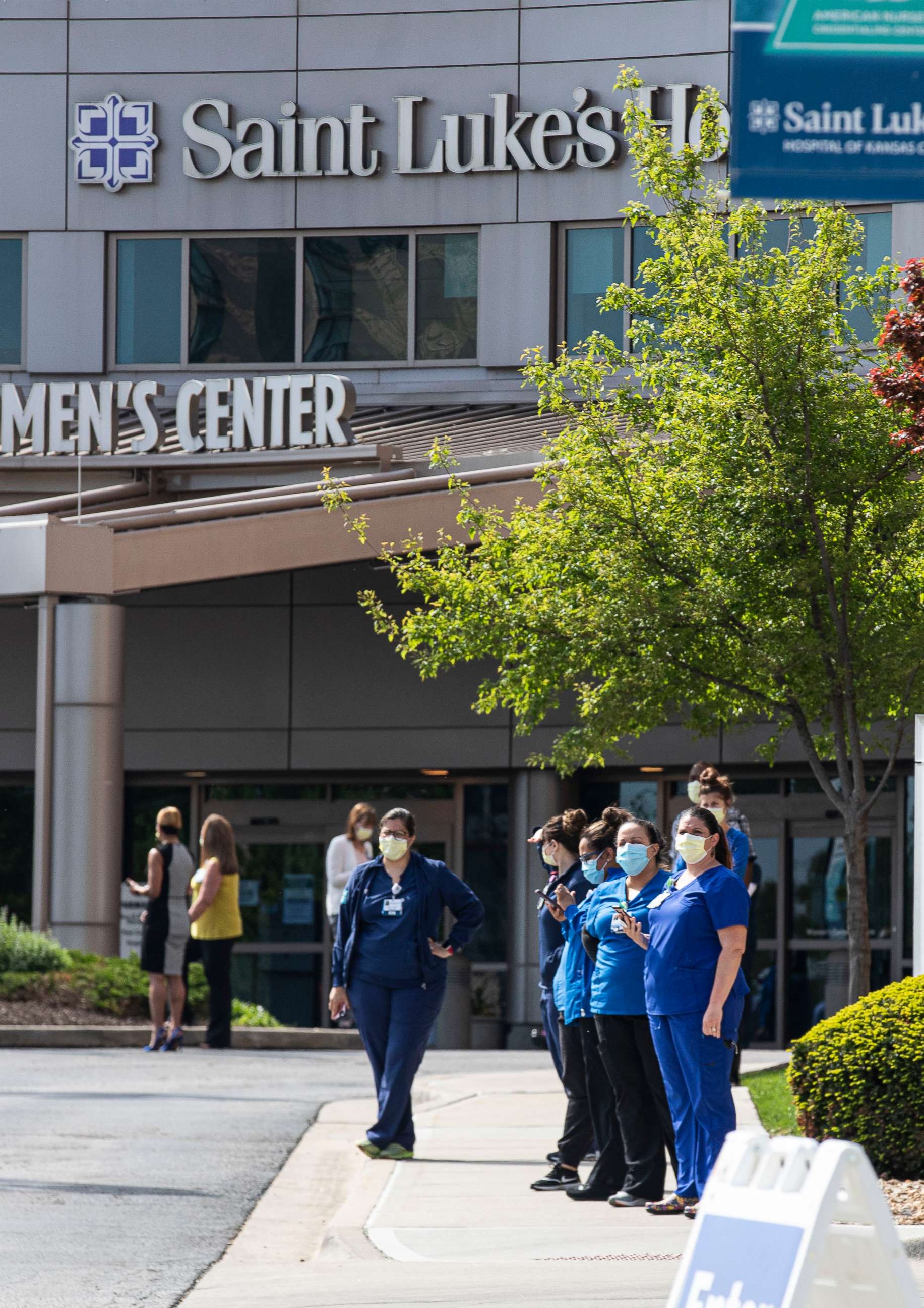 PHOTO: Medical personnel at St. Luke's hospital prepare to watch a flyover by the United States Air Force from Whiteman Air Force Base to honor the fight against Covid-19 in Kansas City, Mo. April 28, 2020.