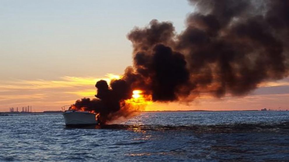 This photo provided by the United States Coast Guard shows a boat on fire. Some Good Samaritans helped rescue four passengers off the South Galveston Jetty in Texas on September 20, 2015. (United States Coast Guard)