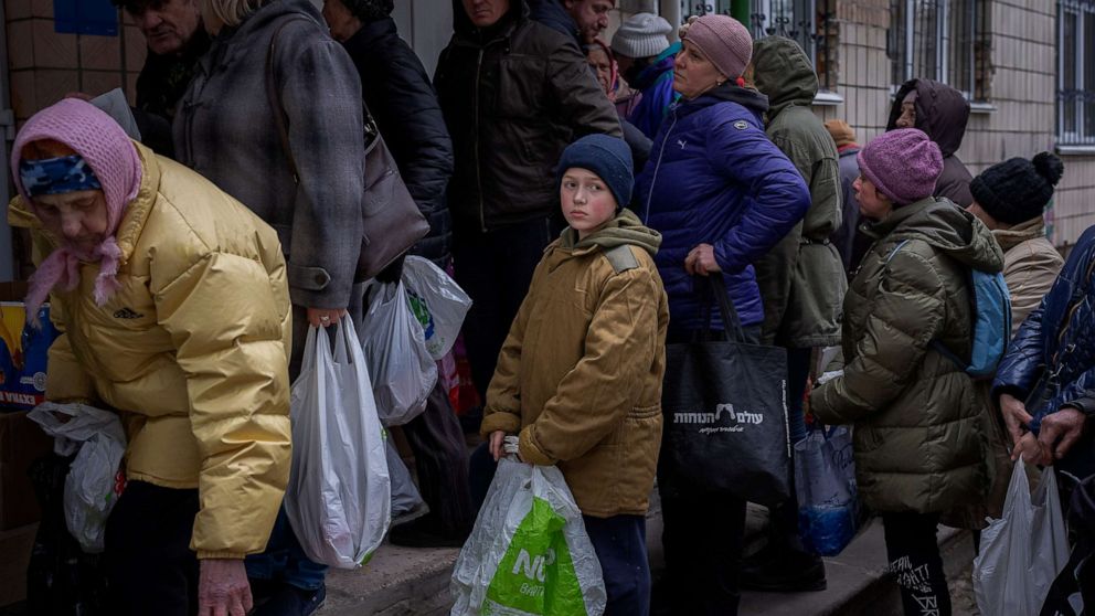 PHOTO: Sergei, 11, waits his turn to receive donated food during an aid humanitarian distribution in Bucha, in the outskirts of Kyiv, Ukraine, April 19, 2022. 