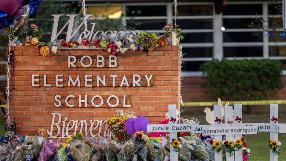 PHOTO: A memorial is seen surrounding the Robb Elementary School sign following the mass shooting at Robb Elementary School, May 26, 2022, in Uvalde, Texas. 