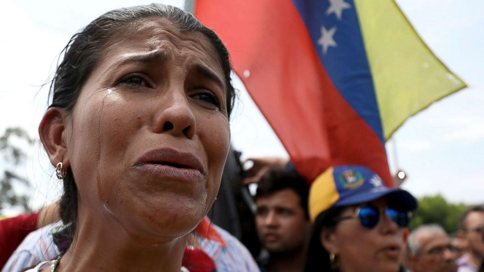 PHOTO: Venezuelan migrant Yanela Aleman cries as she sings her national anthem in La Parada, near Cucuta, Colombia, on the border with Venezuela, Feb. 17, 2019. 