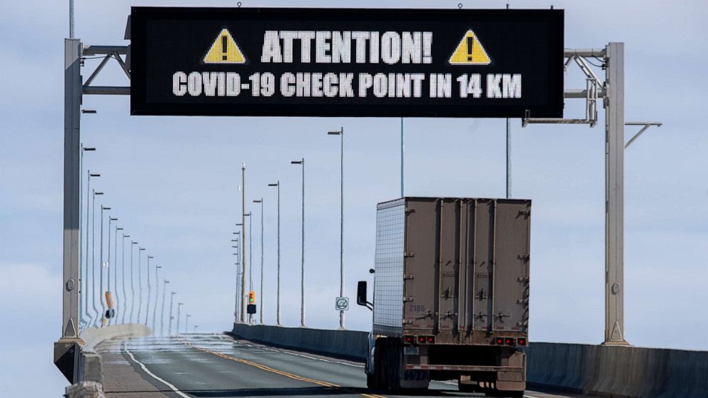 PHOTO: A sign indicates that provincial health department workers will stop traffic that has crossed the Confederation Bridge in Cape Jourimain, New Brunswick. on Sunday, March 22, 2020.