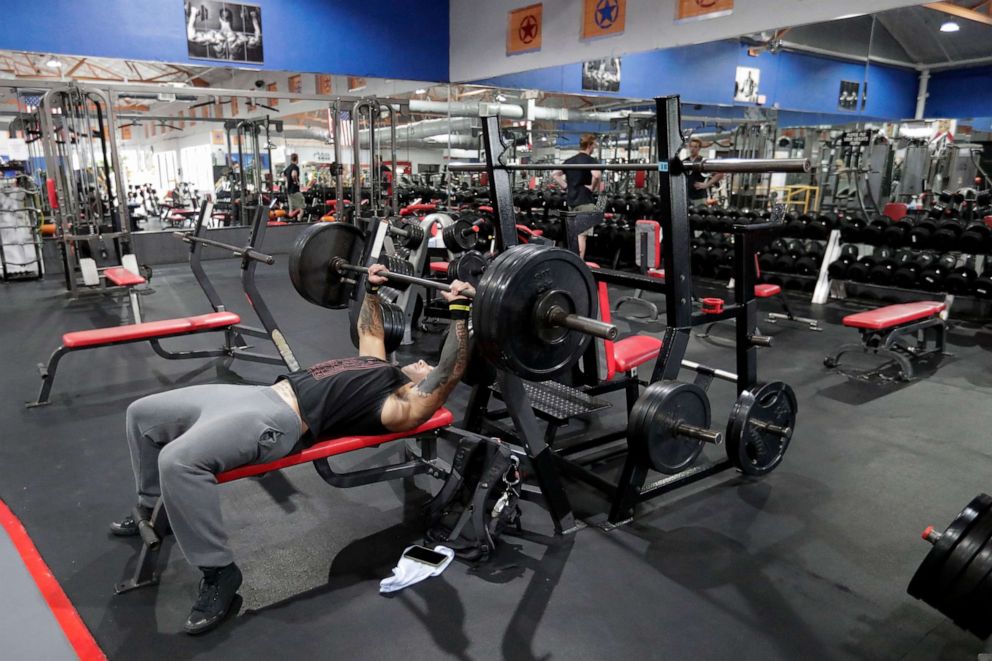 Los Angeles, California, USA. 15th Mar, 2021. A Planet Fitness staff cleans  gym equipment to prepare the reopening after being closed due to Covid-19  pandemic in Inglewood, California, on March 15, 2021.