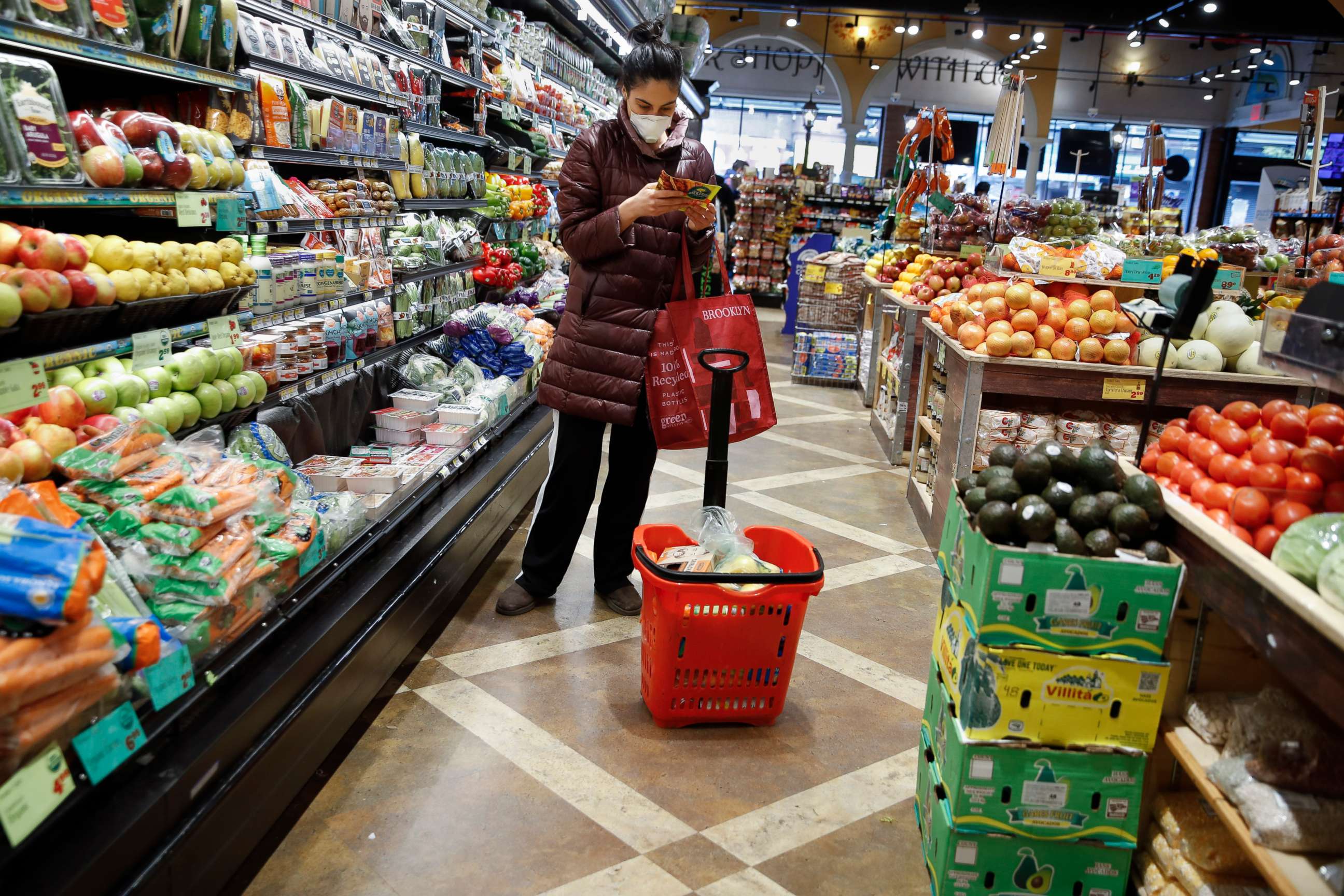 PHOTO: A shopper wears a face mask in the produce section of a grocery store, April 18, 2020, in the Harlem neighborhood of the Manhattan borough of New York, during the coronavirus outbreak.