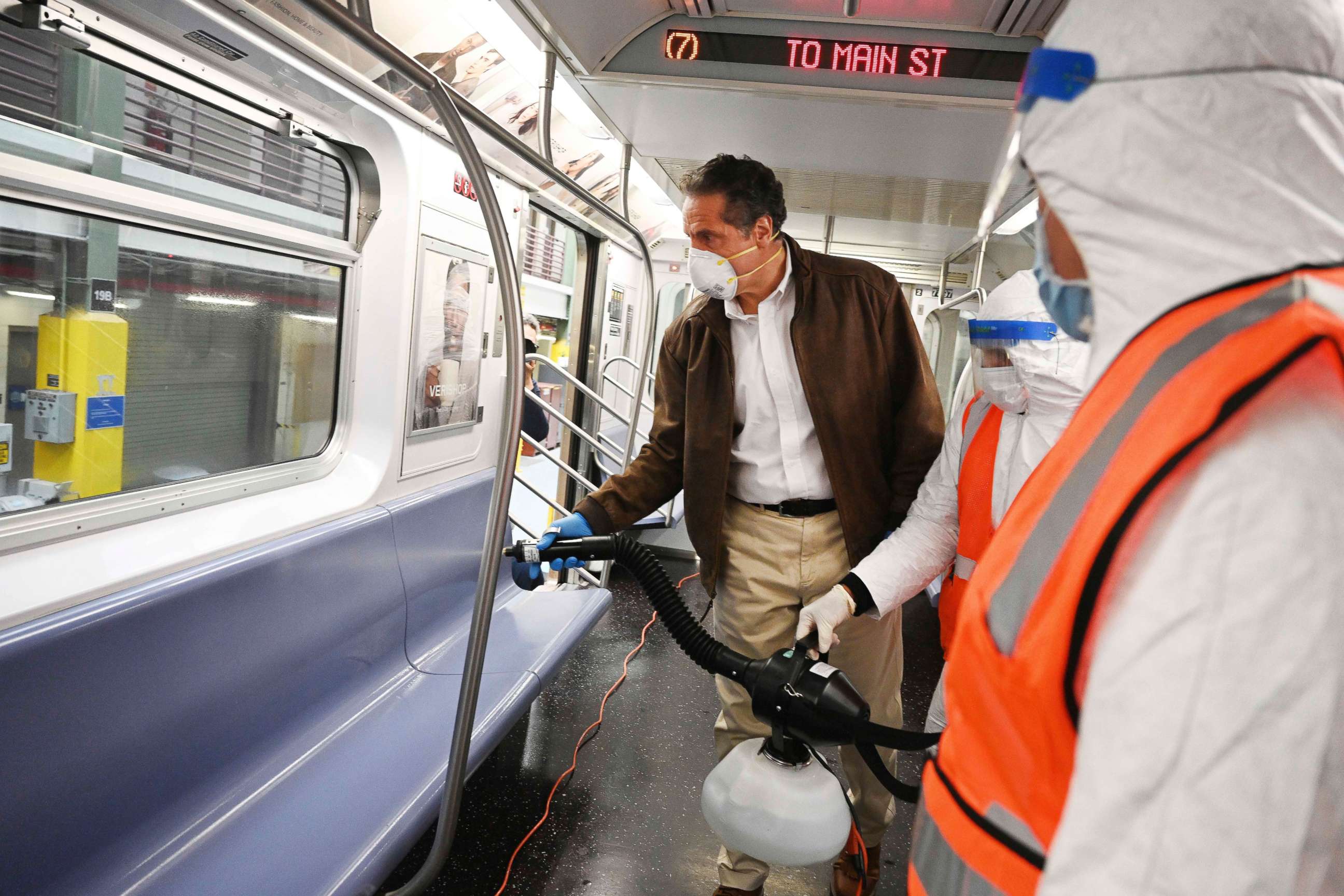 PHOTO: Governor Andrew M. Cuomo, New York Gov. Cuomo tries out a spraying device which is part of a three-step disinfecting process of a New York City subway car at the Corona Maintenance Facility in Queens, New York, on Saturday, May 2, 2020. 