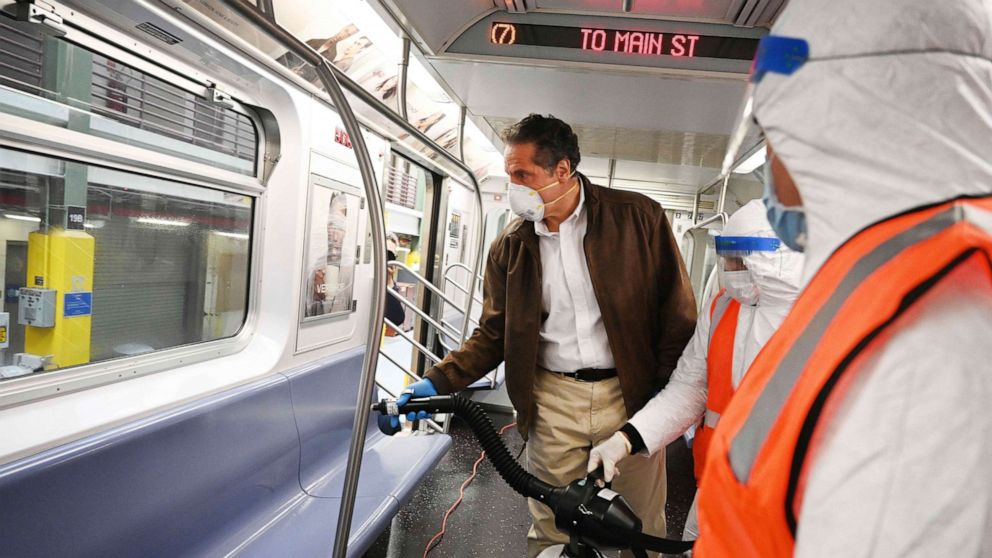 PHOTO: Governor Andrew M. Cuomo, New York Gov. Cuomo tries out a spraying device which is part of a three-step disinfecting process of a New York City subway car at the Corona Maintenance Facility in Queens, New York, on Saturday, May 2, 2020. 