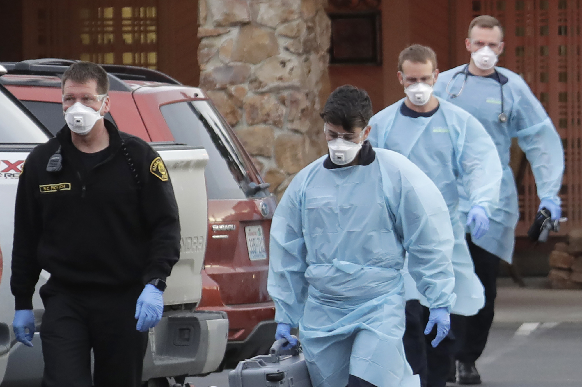 PHOTO: Kirkland Fire and Rescue ambulance workers walk back to a vehicle after a patient was loaded into an ambulance, Tuesday, March 10, 2020, at the Life Care Center in Kirkland, Wash., near Seattle. The nursing home is at the center of the outbreak. 