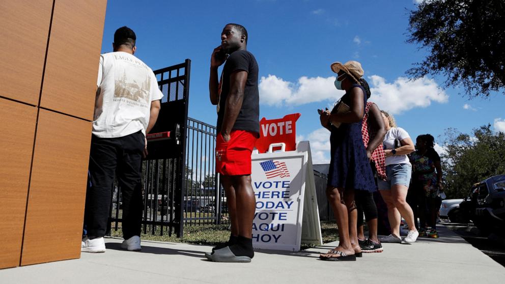 PHOTO: A man waits in line with other community members in East Tampa to enter the C. Blythe Andrews, Jr. Public Library at a early voting polling precinct to cast their ballots in Tampa, Fla., Nov. 2, 2024. 