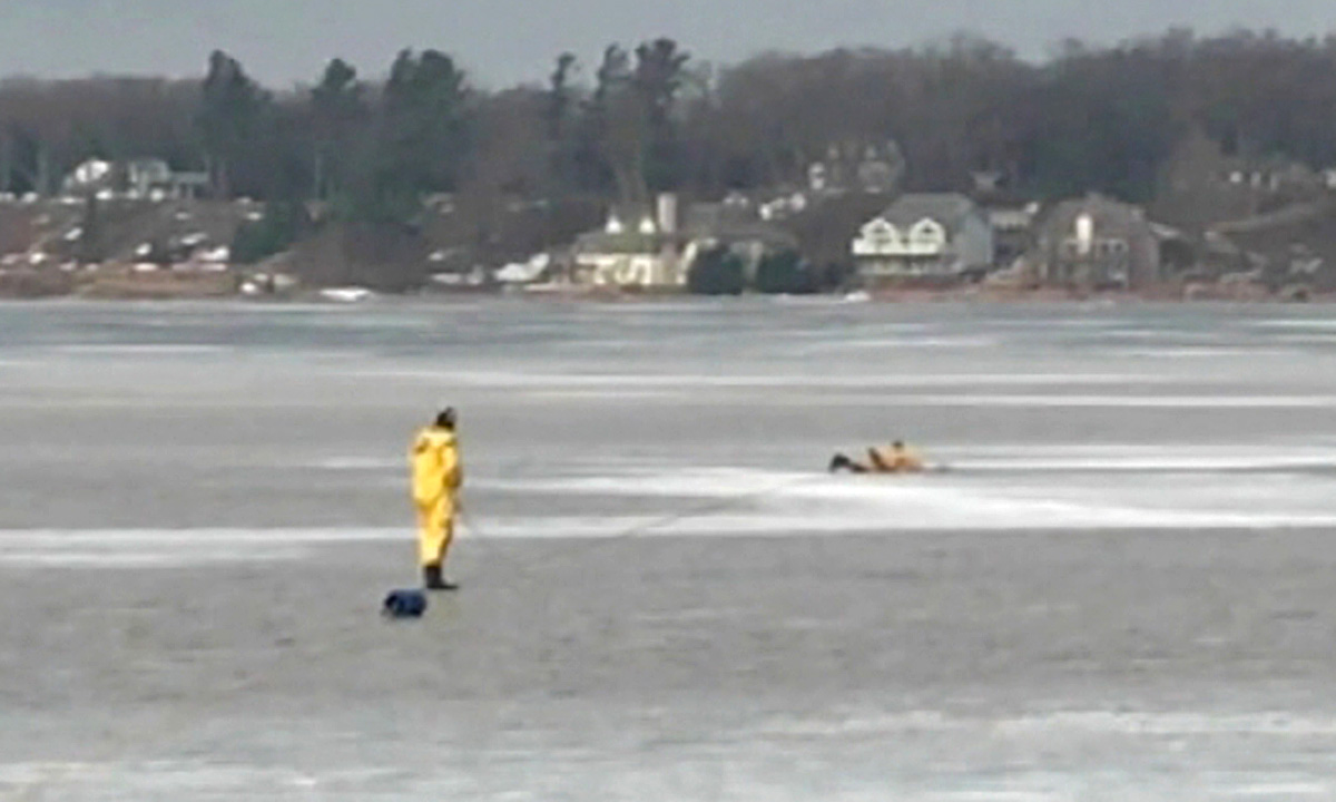 PHOTO: Two firemen from the White Lake Fire Dept. make their way out on the ice in an effort to rescue a dog that had fallen through the ice. 