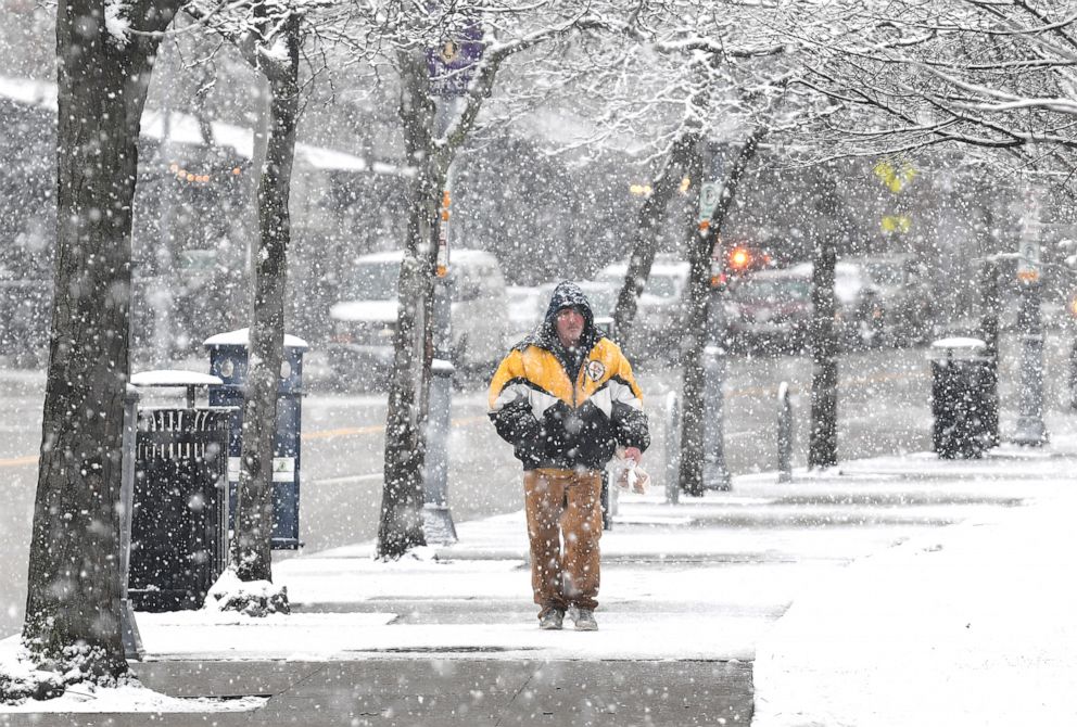 PHOTO: A man makes his way along North Shore Drive as the snow falls, March 9, 2022, on Pittsburgh's North Shore. 