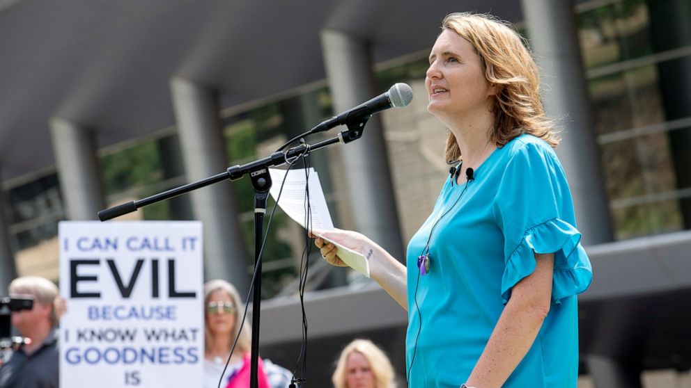 FILE - In this Tuesday, June 12, 2018 file photo, rape survivor and abuse victim advocate Mary DeMuth speaks during a rally protesting the Southern Baptist Convention's treatment of women outside the convention's annual meeting at the Kay Bailey Hutc