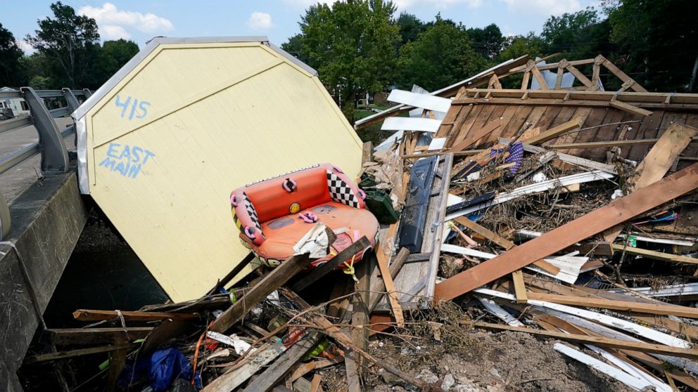 The address of a utility building is painted on the back as it sits lodged against a bridge with other debris, Aug. 25, 2021, in Waverly, Tenn. Ten families are suing CSX Transportation for up to $450 million over flooding that killed 20 people in Te