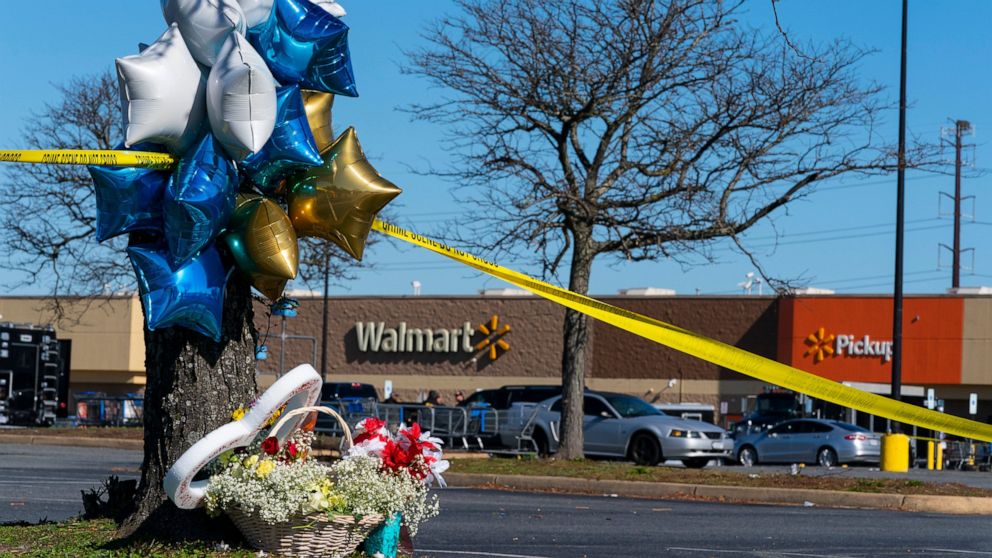 Flowers and balloons have been placed near the scene of a mass shooting at a Walmart, Wednesday, Nov. 23, 2022, in Chesapeake, Va. A Walmart manager opened fire on fellow employees in the break room of the Virginia store, killing several people in th