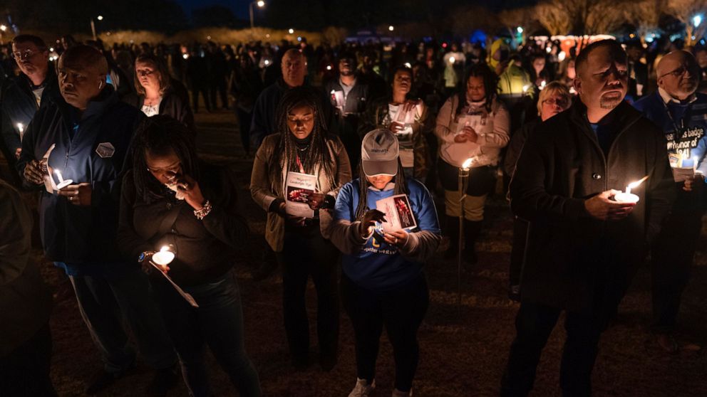 Community members, including Walmart employees, gather for a candlelight vigil at Chesapeake City Park in Chesapeake, Va., Monday, Nov. 28, 2022, for the six people killed at a Walmart in Chesapeake, Va., when a manager opened fire with a handgun bef