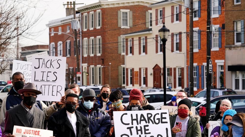FILE - Protesters demonstrate calling for police accountability in the death of 8-year-old Fanta Bility who was shot outside a football game, at the Delaware County Courthouse in Media, Pa., on Jan. 13, 2022. Three former police officers charged with