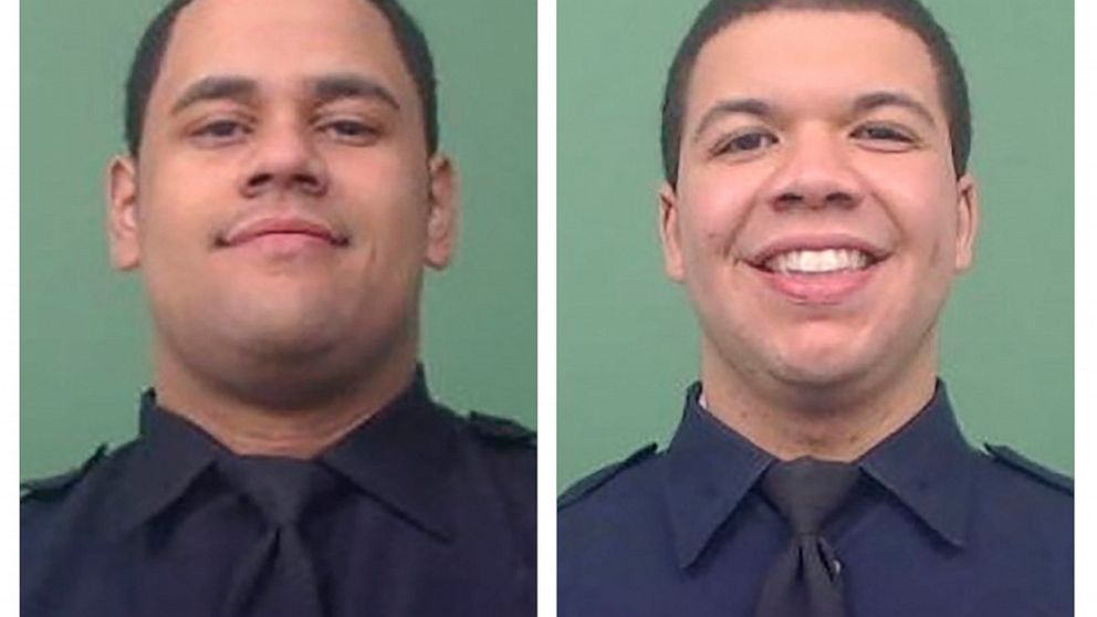 This photo combo of images provided by the New York City Police Department shows NYPD Officers Wilbert Mora, left, and Jason Rivera. The two officers were shot while answering a call about an argument between a woman and her adult son in the Harlem n