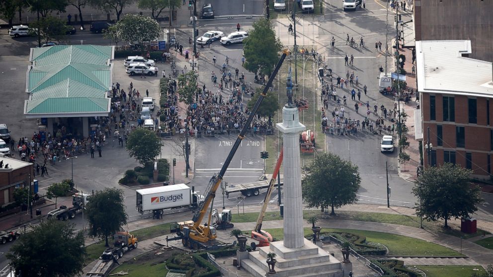 FILE -Workers prepare to take down the statue of former confederate general Robert E. Lee, which stands over 100 feet tall, in Lee Circle in New Orleans, Friday, May 19, 2017. A round patch of New Orleans green space where a larger-than-life statue o