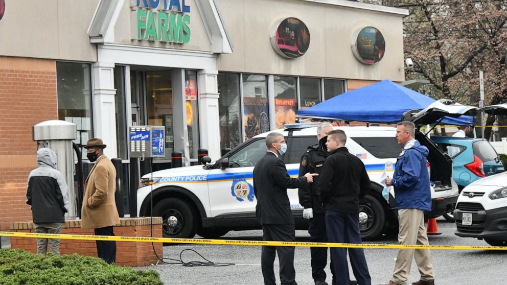 Baltimore County police investigate a shooting Sunday, March 28, 2021 at the Royal Farms in Essex, Md. Police say two people have been killed and a third person injured in a shooting at a Maryland convenience store and gas station. The Baltimore Sun 