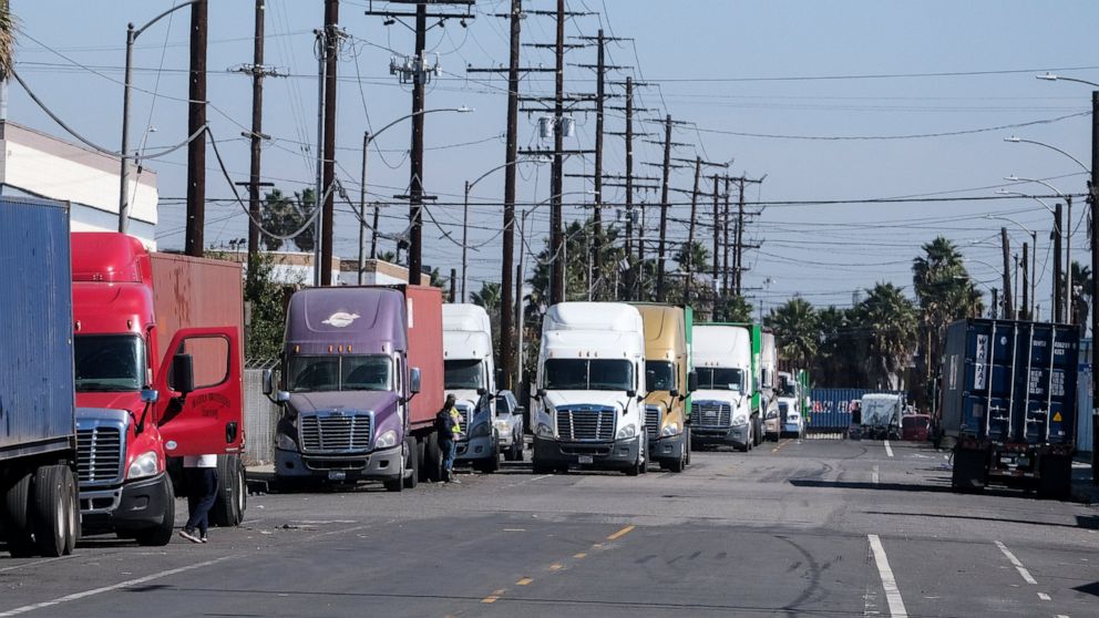 Parked cargo container trucks are seen in a street, Wednesday, Oct. 20, 2021 in Wilmington, Calif. California Gov. Gavin Newsom on Wednesday issued an order that aims to ease bottlenecks at the ports of Los Angeles and Long Beach that have spilled ov