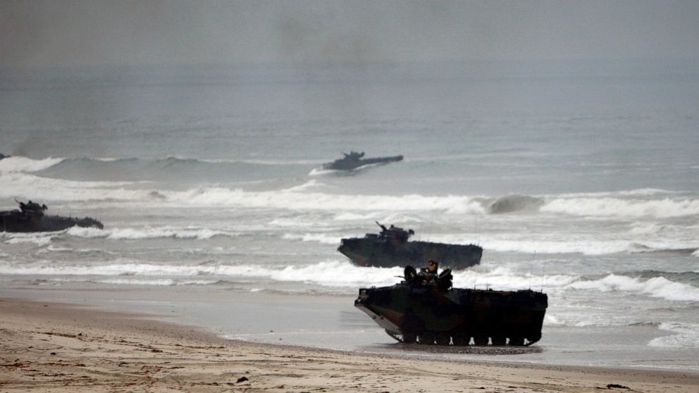 FILE - Amphibious Assault Vehicles storm Red Beach during exercises at Camp Pendleton, Calif., June 2, 2010. The Marine Corps has halted some operations of its Amphibious Combat Vehicle after one of the armored vehicles rolled over in surf during tra