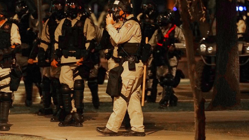 Riot police surround the Arizona Capitol after protesters reached the front of the Arizona Sentate building following the Supreme Court's decision to overturn Roe v. Wade Friday, June 24, 2022, in Phoenix. (AP Photo/Ross D. Franklin)