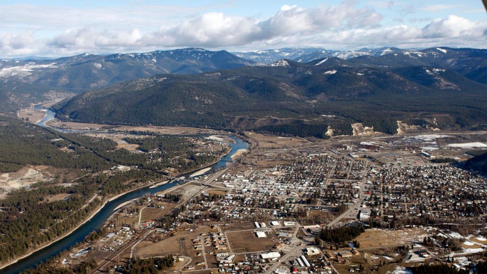 FILE - This Feb. 17, 2010, aerial file photo, shows the town of Libby, Mont. Mine workers in Libby who were sickened and killed by toxic asbestos exposure and their heirs are suing an insurance company for allegedly stalling legal settlements and med