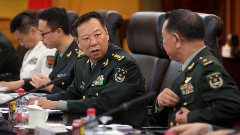 FILE - China's People's Liberation Army (PLA) Gen. Li Zuocheng, center, speaks during a meeting with U.S. Army Chief of Staff Gen. Mark Milley, not shown, at the Bayi Building in Beijing on Aug. 16, 2016. China has demanded the U.S. cease military "c